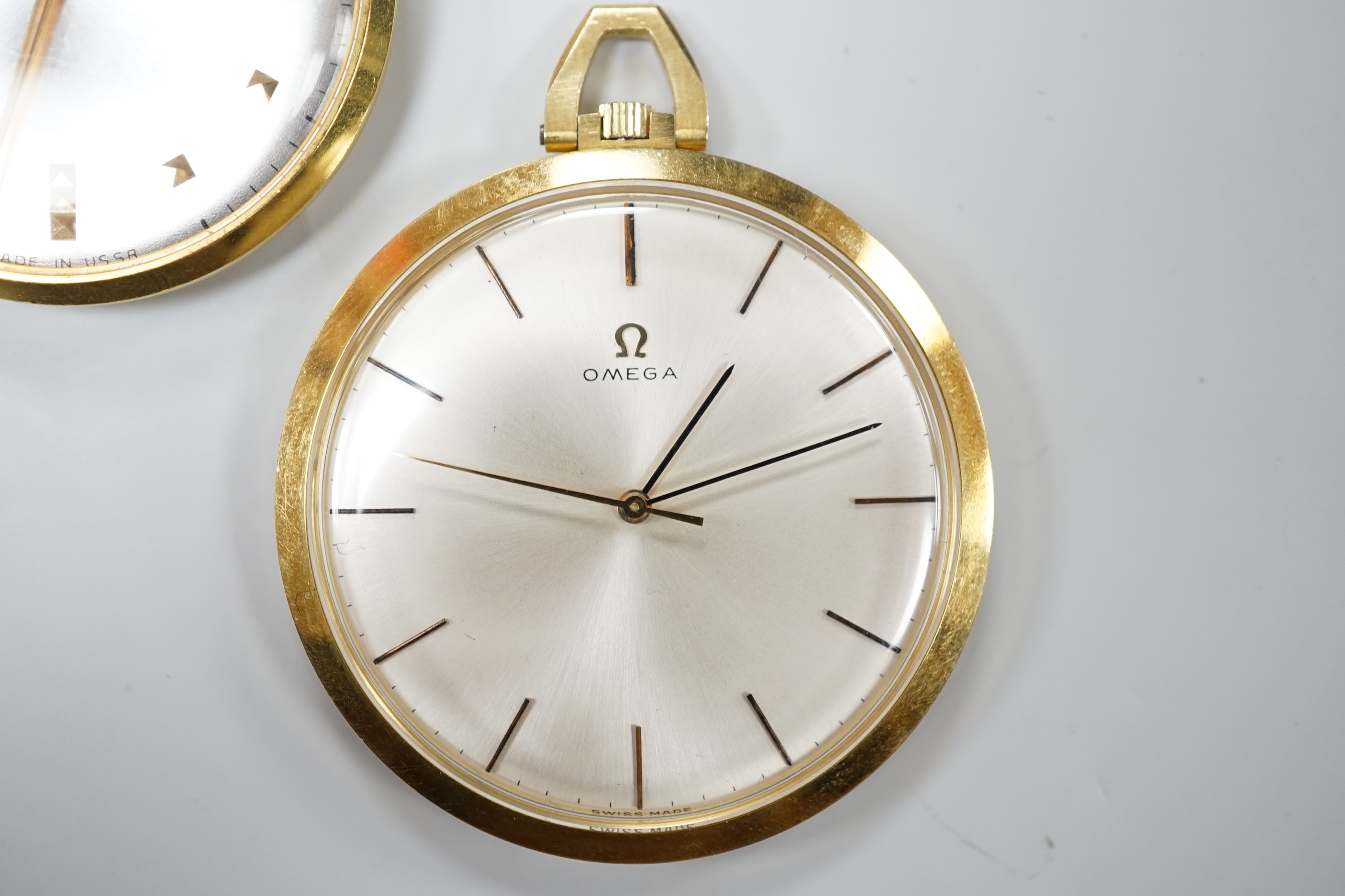 A 750 yellow metal Omega open faced keyless dress pocket watch, case diameter 42mm, gross weight 43.1 grams and a Rukela dress pocket watch.